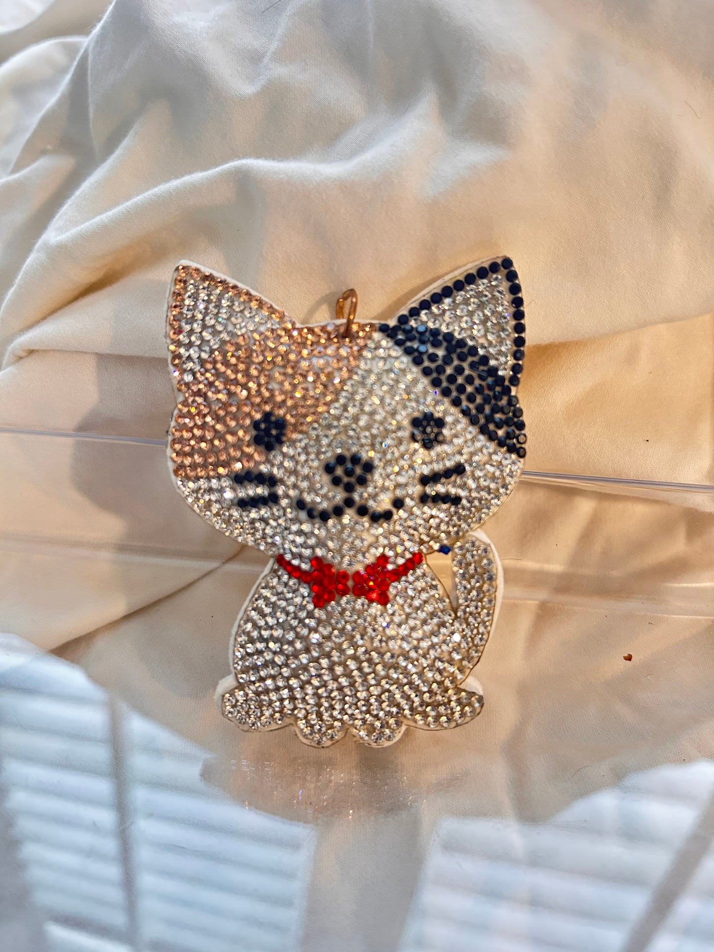 Cat keychain featuring a charming hand plushed texture
It wears a signature red bowtie and a premium gold clasp closure.
Whimsical accessory to elevate any handbag, backpack, or of course set of keys.