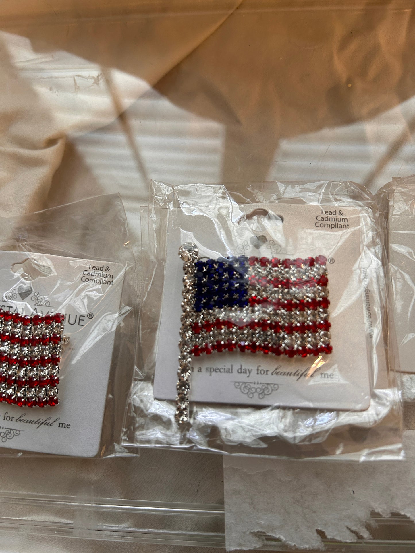 Showcase your patriotic pride with this stunning crystal rhinestone American flag pin. Dynamic waving flag design.  Mounted on a silver tone base. Fully encrusted flagpole detail for an extra touch of sophistication.  Suitable for July 4, Veterans Day, Memorial Day, or Labor Day