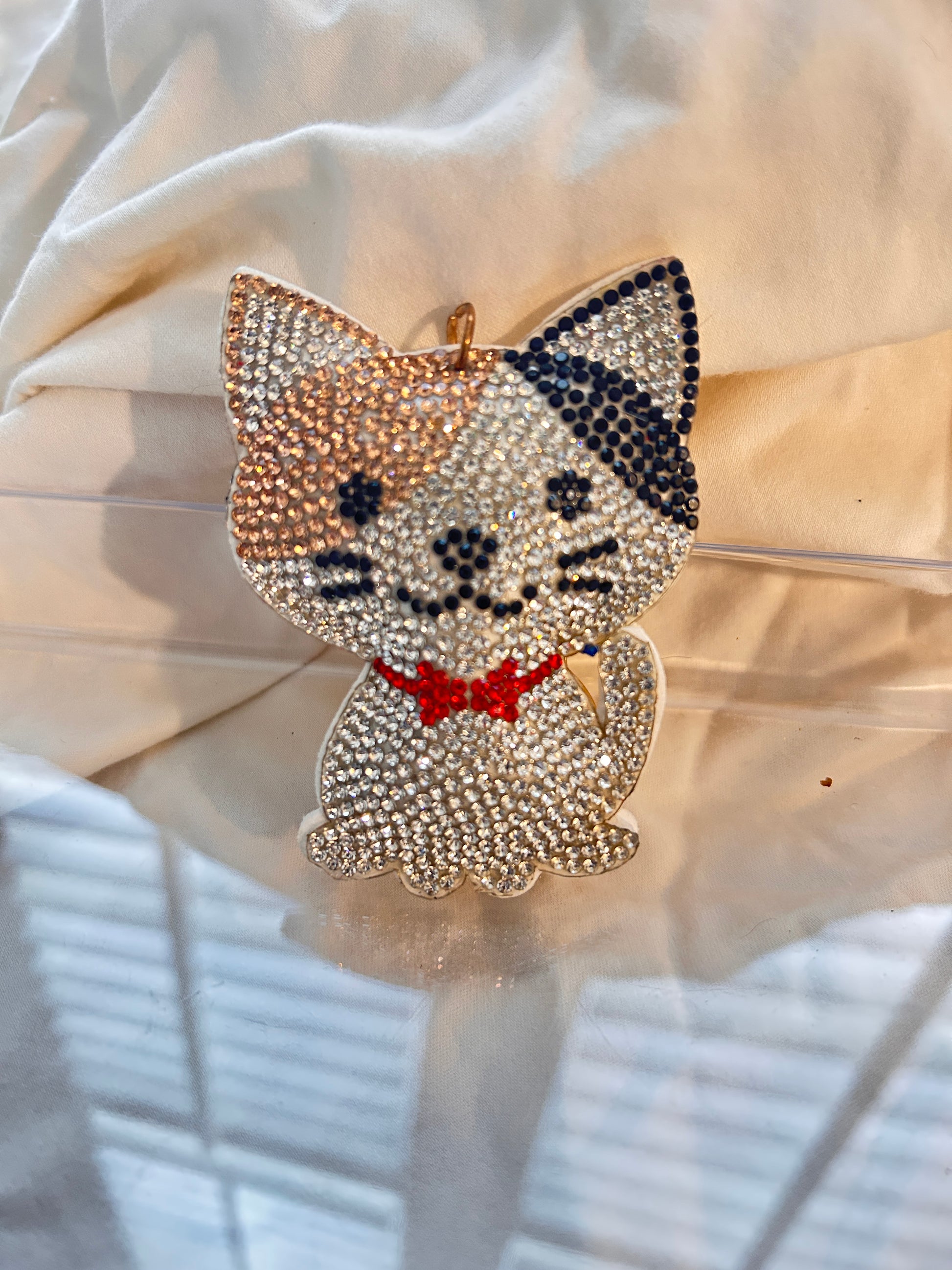 Cat keychain featuring a charming hand plushed texture&nbsp;

It wears a signature red bowtie and a premium gold clasp closure.&nbsp;

Whimsical accessory to elevate any handbag, backpack, or of course set of keys.