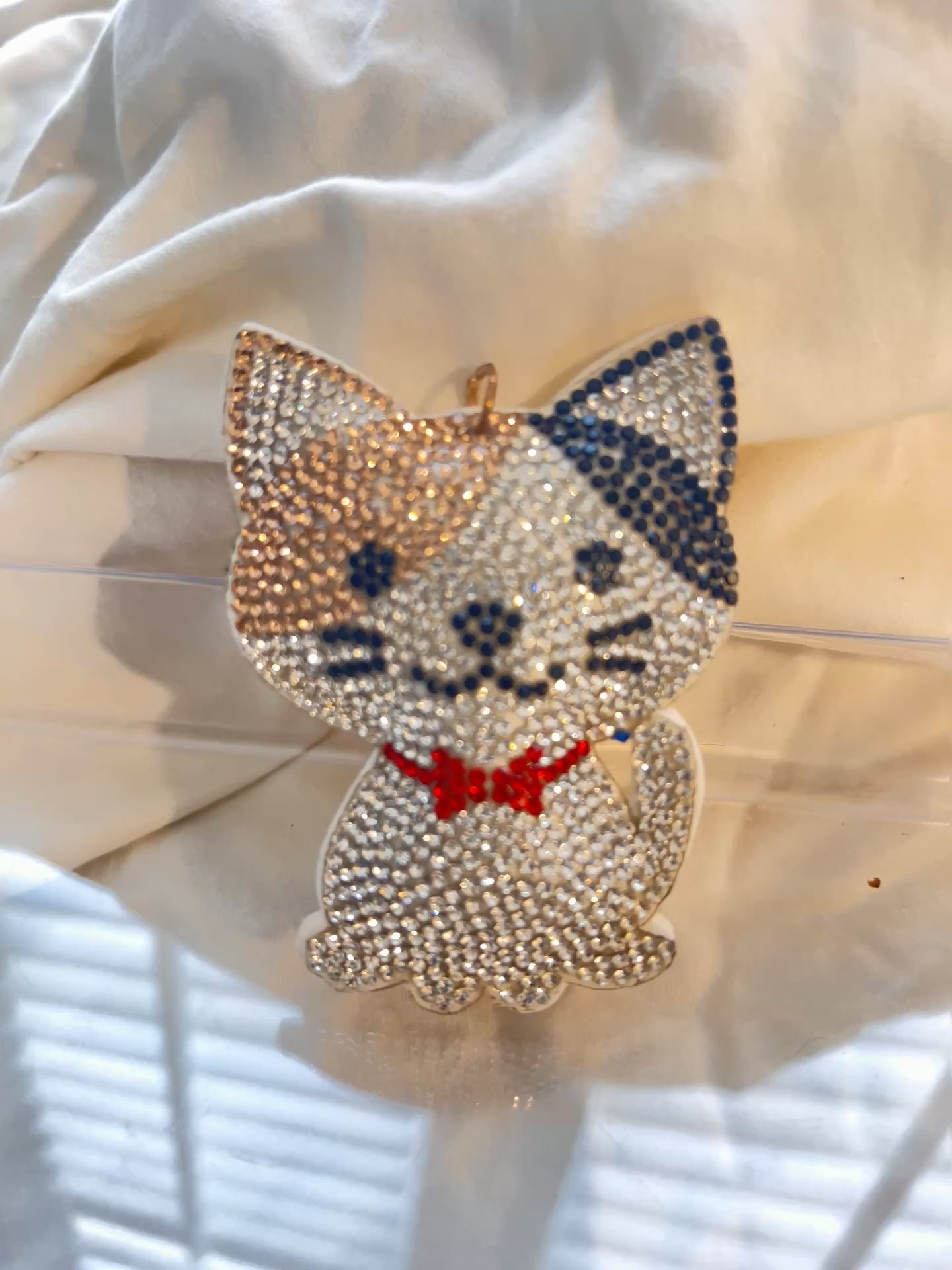 Cat keychain featuring a charming hand plushed texture&nbsp;

It wears a signature red bowtie and a premium gold clasp closure.&nbsp;

Whimsical accessory to elevate any handbag, backpack, or of course set of keys.